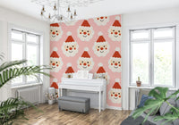 A cute kids’ Christmas wallpaper featuring friendly Santa smiles in a repeating pattern.