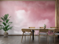 Pink Sky And Clouds wallpaper with rosy cloud gradient behind a wooden dining table and palm in a dining room