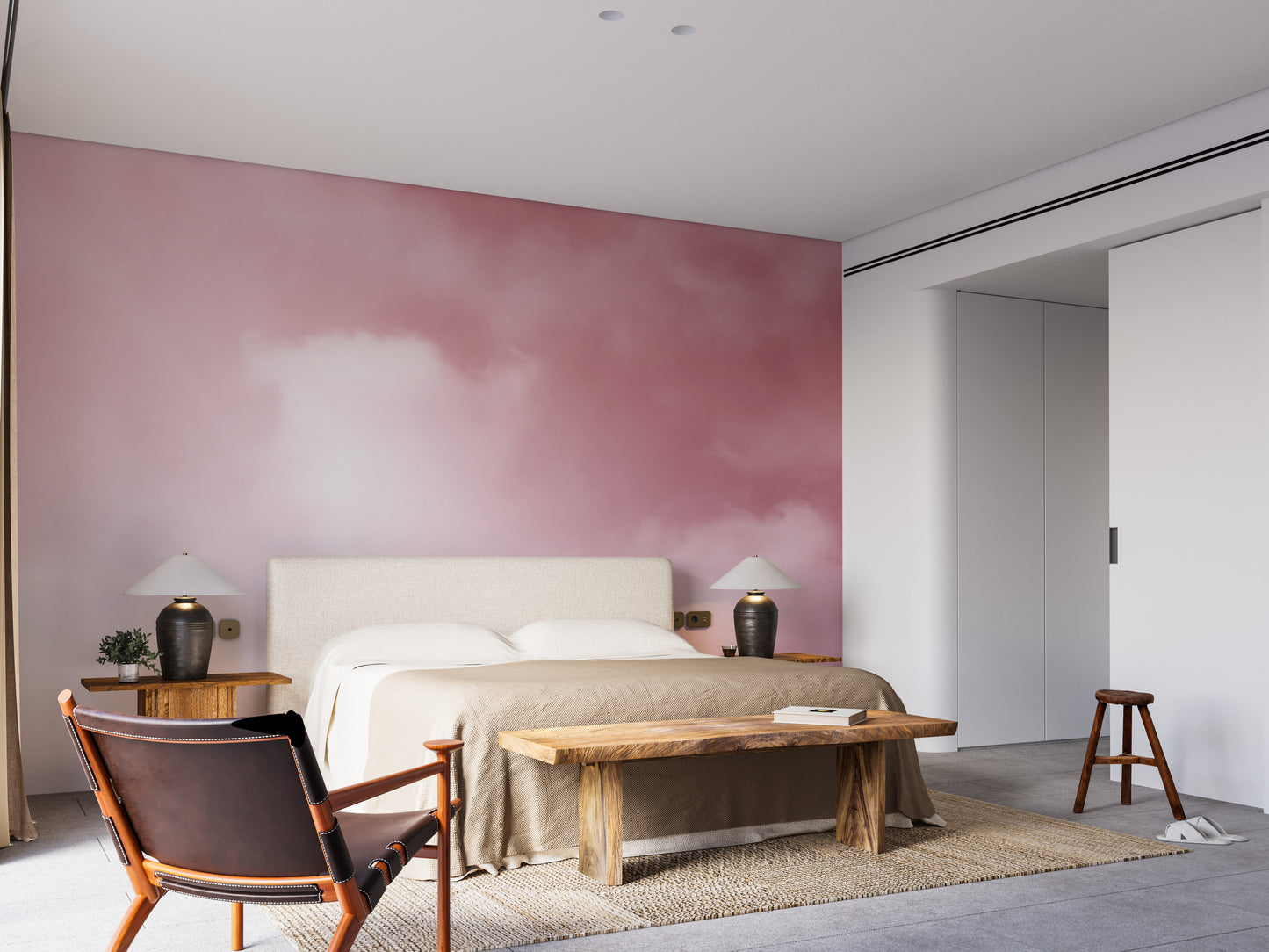 Pink Sky And Clouds wallpaper with soft rose clouds behind an upholstered bed and wood bench in a bedroom