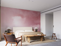 Pink Sky And Clouds wallpaper with soft rose clouds behind an upholstered bed and wood bench in a bedroom