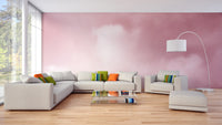 Pink Sky And Clouds wallpaper in dreamy pink behind a cream sectional sofa and arc lamp in a living room