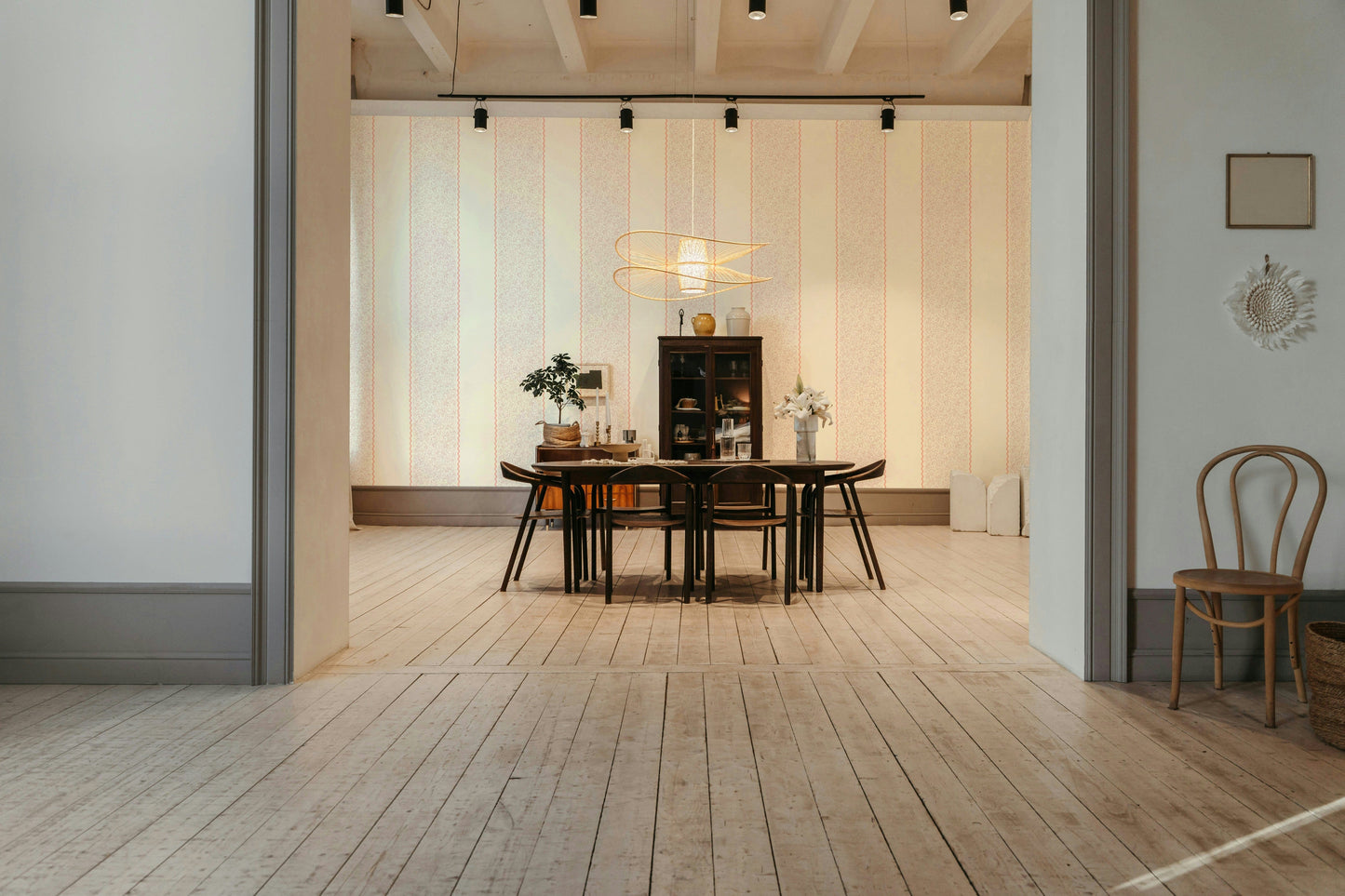 The design features a repeating pattern of classic stripes and delicate flourish shapes.

