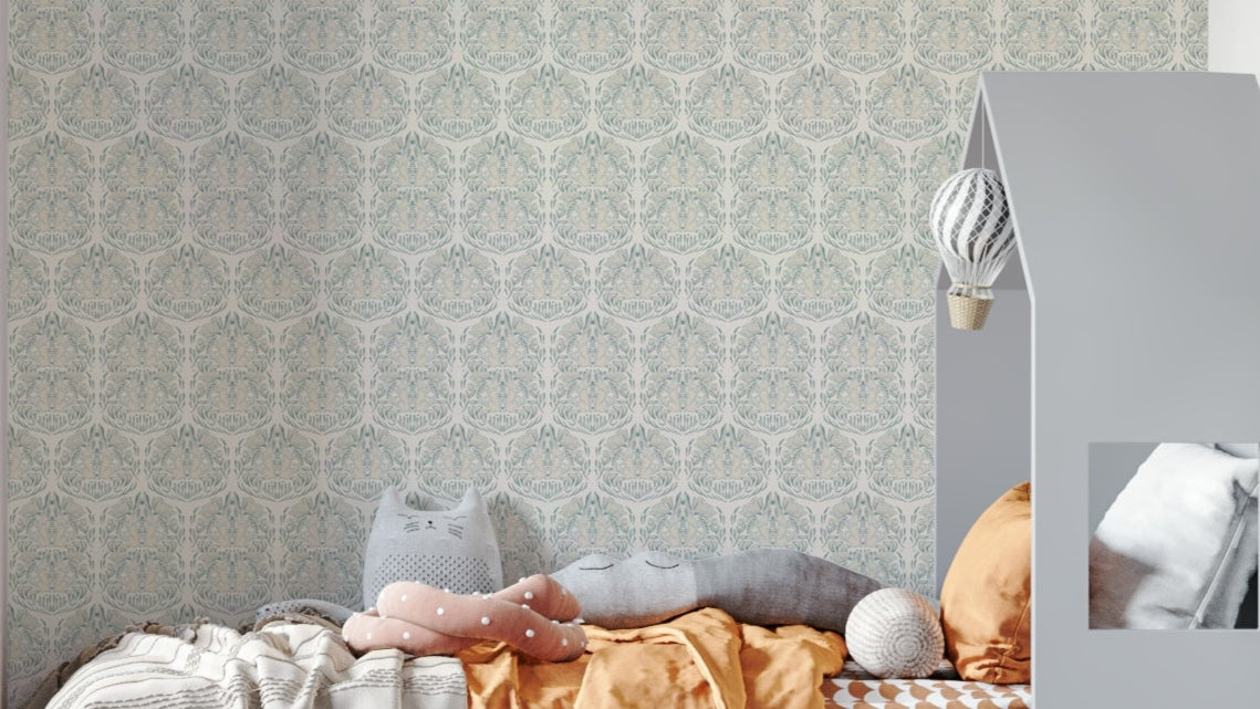 Poppy and the Hare Morning Light wallpaper mural in sage and cream behind a child bed with cat cushions in a nursery
