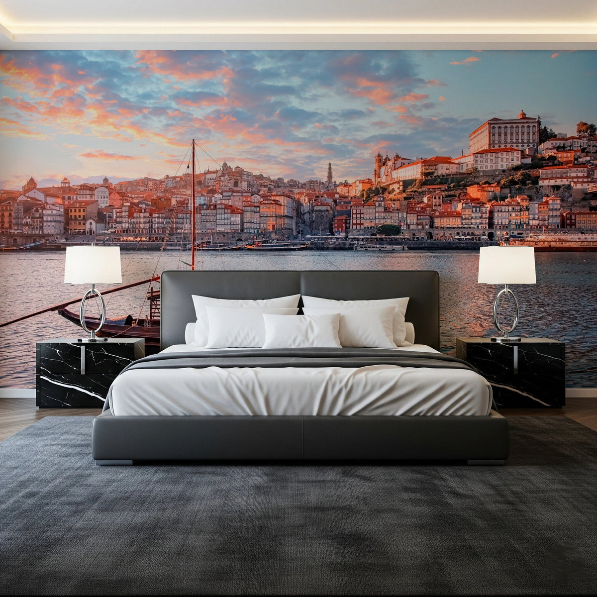 Porto Sunset Glow wallpaper mural of the Douro riverfront at dusk behind a grey bed and black marble nightstands