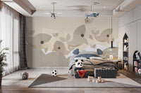 Whimsical whale pattern mural on canvas material in a kid's bedroom with a navy blue bed and scattered floor toys.