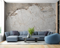 Elegant Gray Marble wallpaper mural with gold veining in a living room behind a light blue sectional sofa and accent chair