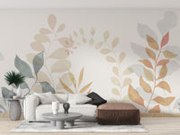 Soft Leaves wallpaper mural with watercolor foliage behind a white sofa and brown leather pouf