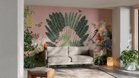 Sunbeam Canopy wallpaper mural with lush palm fan and parrots on a pink wall behind a beige sofa and potted plants in a living room