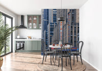 Radio City's Glow wallpaper mural of NYC towers beside a round terrazzo table in a sage green kitchen and dining nook
