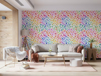 Modern boho nursery with heart print wallpaper and natural wood.