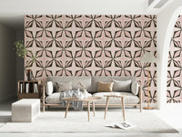 Modern wall mural, dark brown shapes on a subtle pink background.