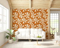 Retro bloom burst wallpaper featuring cream starburst flowers on a warm orange background.
