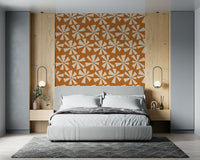 Retro-style wallpaper with bold pinwheel flower motifs in warm earthy tones.