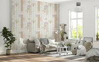 Retro Chic Art Deco wallpaper in pastel geometric pattern behind a grey sofa with wire chair and fiddle-leaf plant