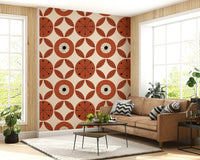 Mid-century floral wallpaper with geometric blooms and symmetrical leaf accents in warm tones.