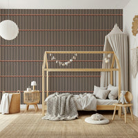 Retro Lines wallpaper in brown and black behind a wood house-frame bed in a neutral kids room