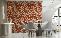 Geometric floral wallpaper showcasing bold pinwheel bursts in a warm retro palette.