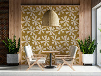 Patterned wallpaper featuring stylized cream floral bursts across a textured golden background.