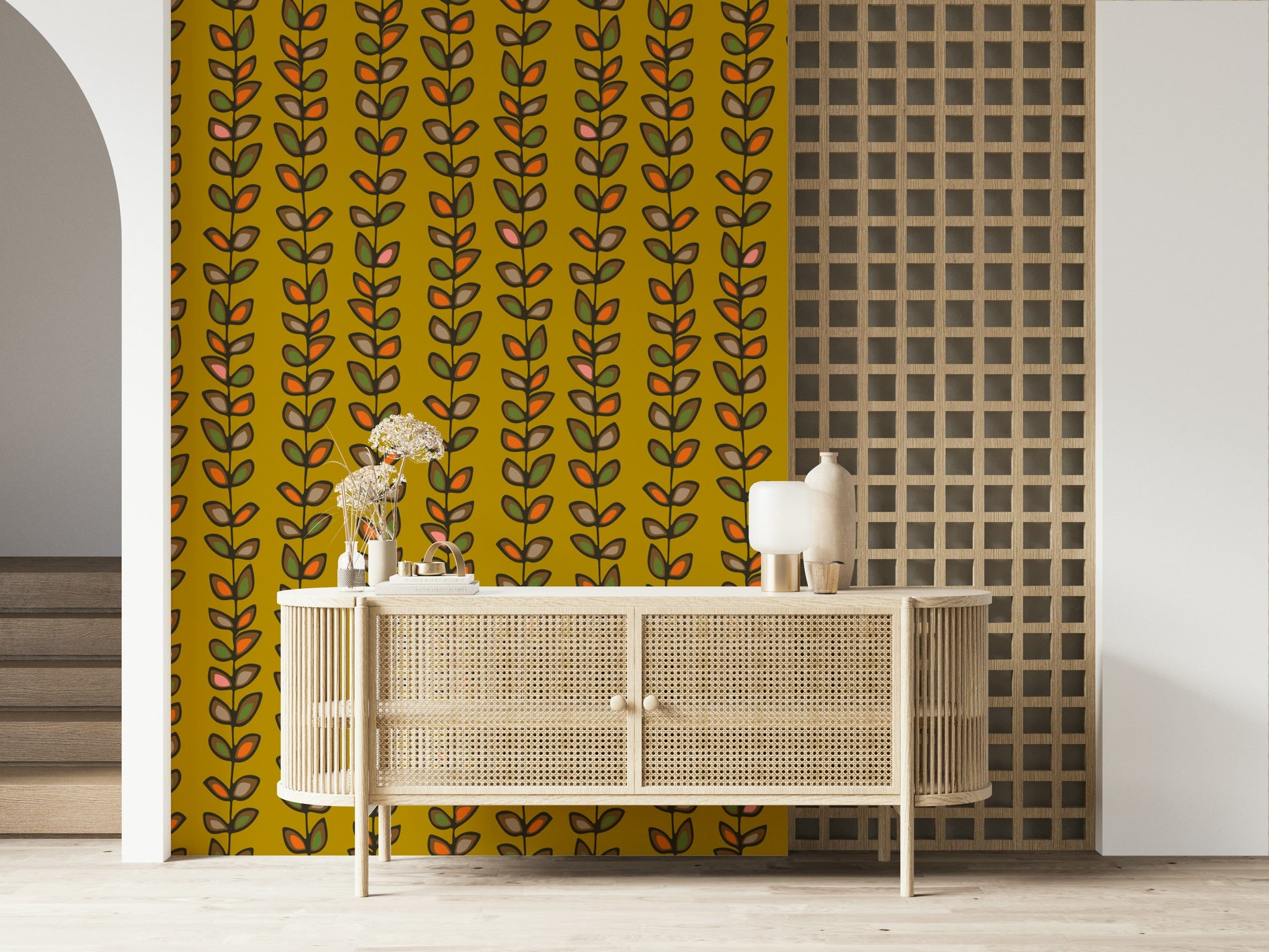 Mustard yellow wallpaper decorated with repeating vine stripes and outlined retro-style leaf motifs.