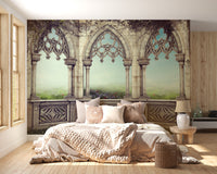 Retro Vintage Garden View wallpaper with Gothic arches over a meadow behind a cream tufted bed in a bedroom