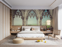 Retro Vintage Garden View wallpaper with arches and wildflowers behind a white bed and rattan chair in a bedroom