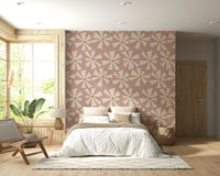 Abstract bloom pattern with radiating cream petals scattered across a pink-textured field.