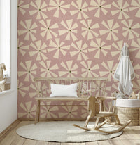 Retro floral wallpaper showcasing geometric starburst petals in a muted rose palette.