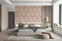Mid-century inspired wallpaper with abstract pinwheel flowers in cream against a soft pink backdrop.