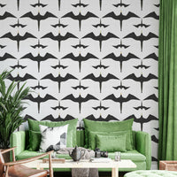 Frigatebirds in motion on rustic white wall covering

