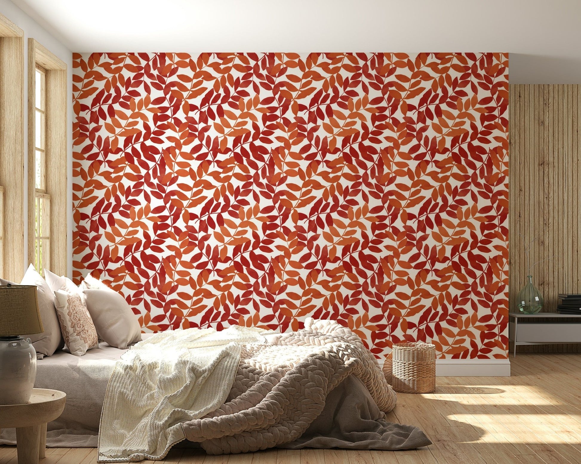 Rustic Leaves wallpaper with red and orange foliage behind a cream bed in a warm bedroom