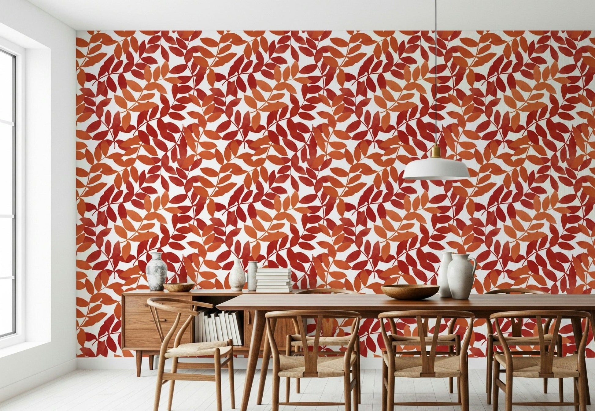 Rustic Leaves wallpaper in red and orange behind a wooden table and wishbone chairs in a dining room