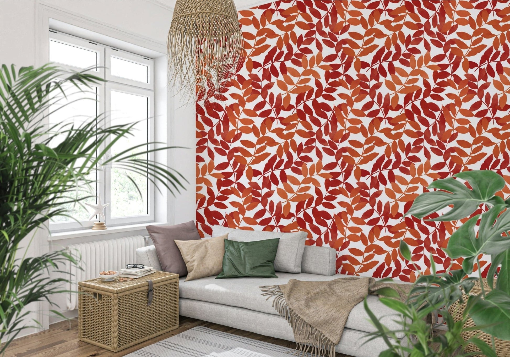 Rustic Leaves wallpaper in red and orange behind a grey daybed with plants in a sunny living room