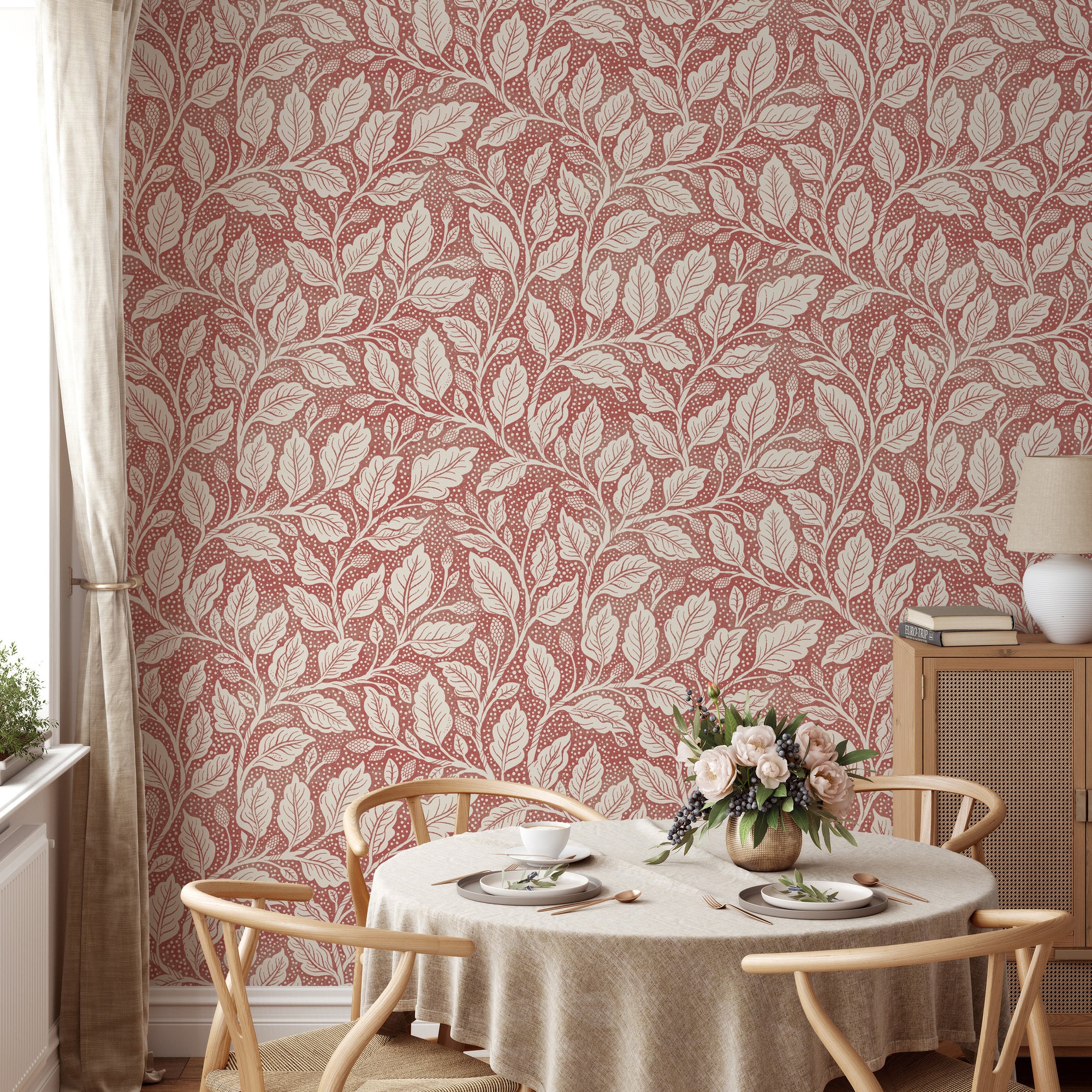 Rustic Red Budding Branches wallpaper with cream leaves on dusty red in a dining room with wishbone chairs and roses