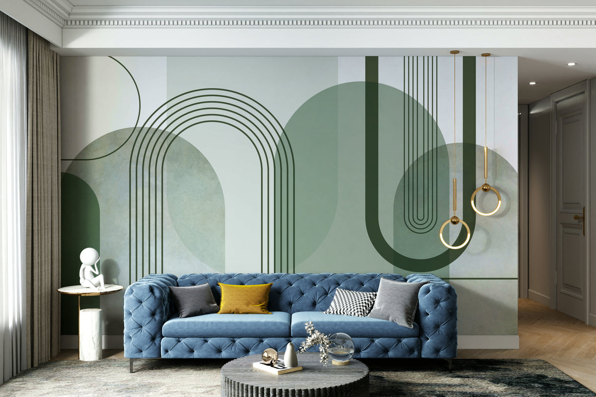 Sage Green Archways wallpaper mural behind a blue tufted sofa with mustard cushions and gold ring pendants in a living room