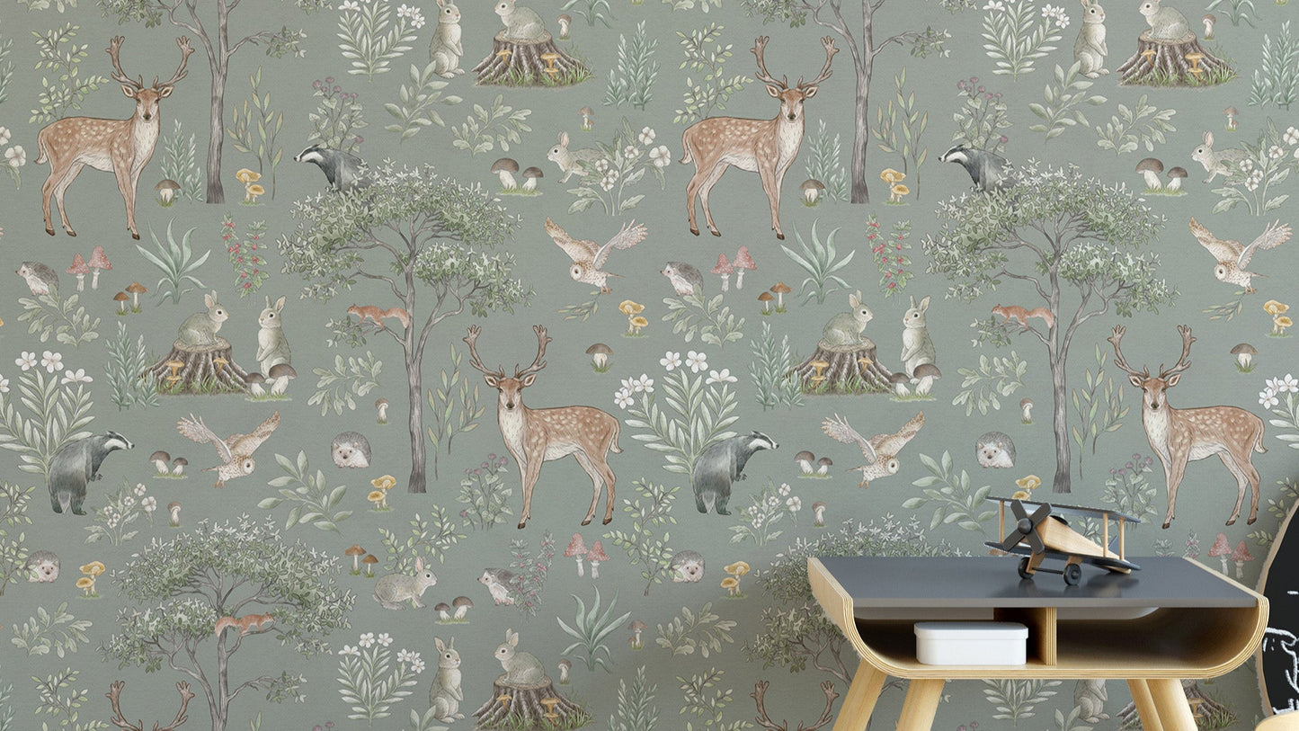 Sage Green Wildlife wallpaper with deer, badgers and owls behind a dark wood side table in a kids room