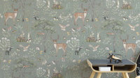 Sage Green Wildlife wallpaper with deer, badgers and owls behind a dark wood side table in a kids room