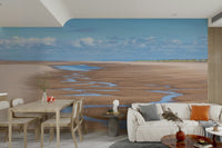 Calm beach wall mural with soft clouds and winding tide lines.

