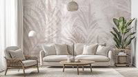 Scandinavian Leaf Elegance wallpaper mural in blush palm leaves behind a cream sofa and rattan armchair in a living room