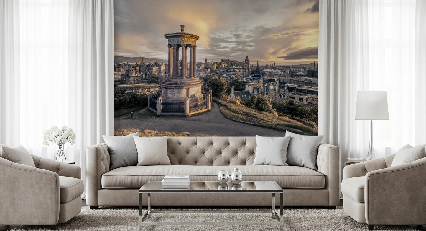 Scottish Skyline wallpaper mural of Edinburgh at sunset above a beige tufted sofa with flanking armchairs