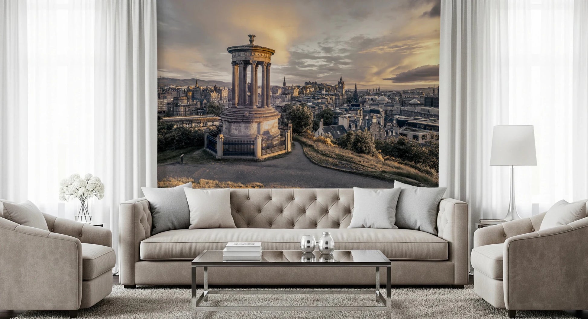 Scottish Skyline wallpaper mural of Edinburgh at sunset above a beige tufted sofa with flanking armchairs