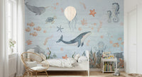 Cute ocean animals wall mural for nursery, pastel color palette, feature wall behind crib