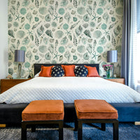 Coastal summer wallpaper with detailed shell patterns in blue.

