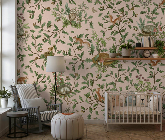 Secret Grove wallpaper mural with blush-pink woodland of owls and squirrels in a nursery with white crib and rocking chair