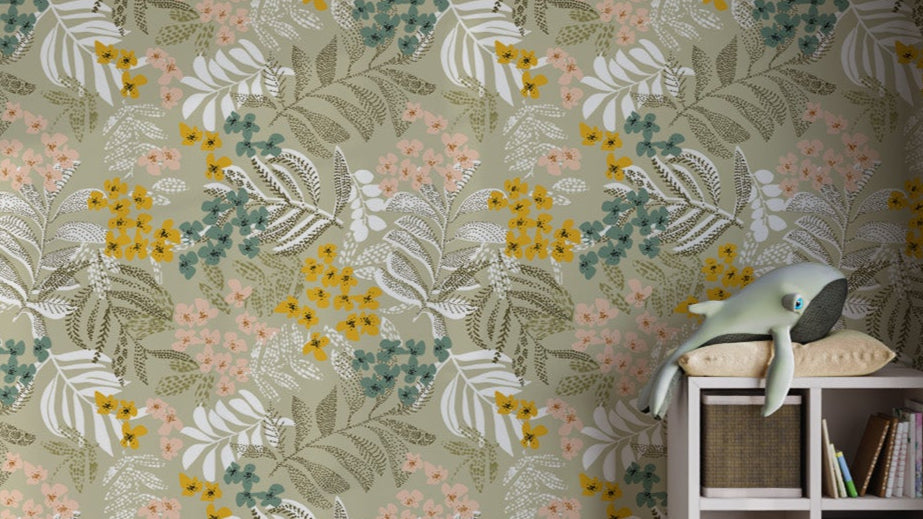 Botanical Harmony wallpaper mural in sage green with yellow and teal flowers beside a white cube shelf and plush whale