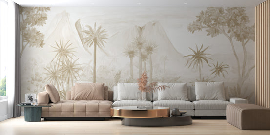 Sepia Forest wallpaper mural of palm trees and misty mountains behind a blush and grey sectional sofa in a living room