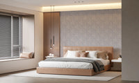 Serene Floral beige wallpaper in soft grey behind a tan leather bed beside a wood panel in a warm bedroom