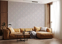 Serene Floral beige wallpaper in soft grey behind a mustard sectional framed by wood walls in a living room