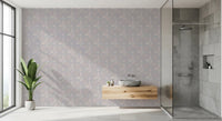 Serene Floral beige wallpaper behind a floating wood vanity and stone basin beside a glass shower in a bathroom