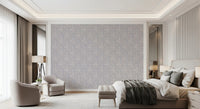 Serene Floral beige wallpaper in grey-lilac blooms behind a beige bed and two cream armchairs in a luxe bedroom