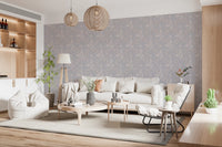 Serene Floral beige wallpaper behind a cream sofa under woven wood pendant lights in a bright living room